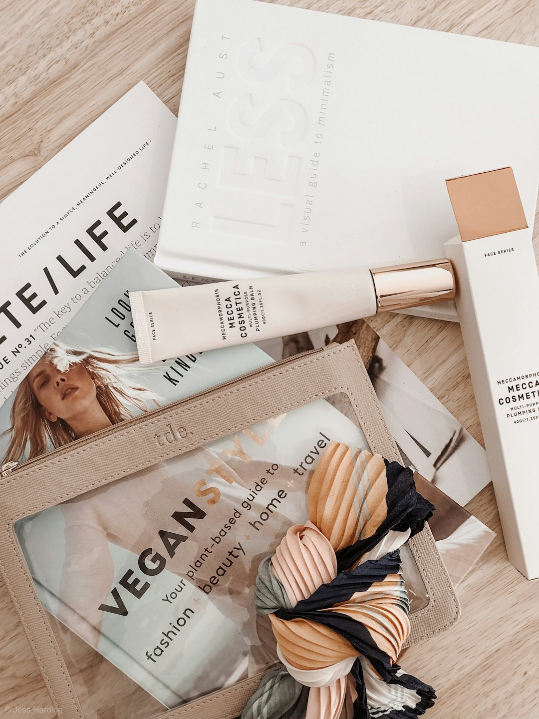 Lifestyle products and books arranged on a wooden surface.